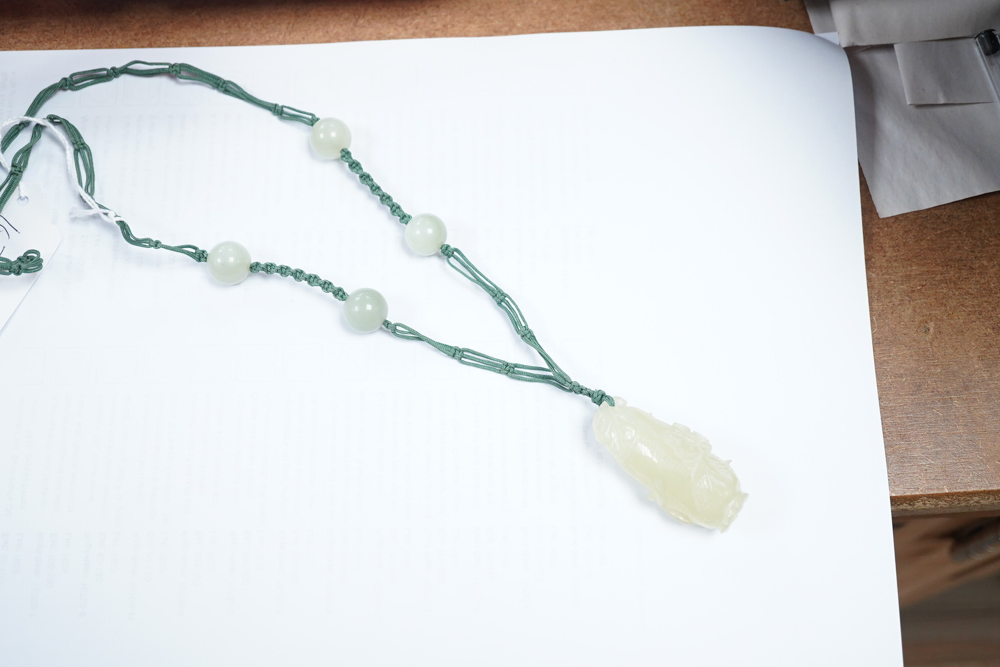 A Chinese bowenite jade pendant and bead necklace. Condition - fair to good